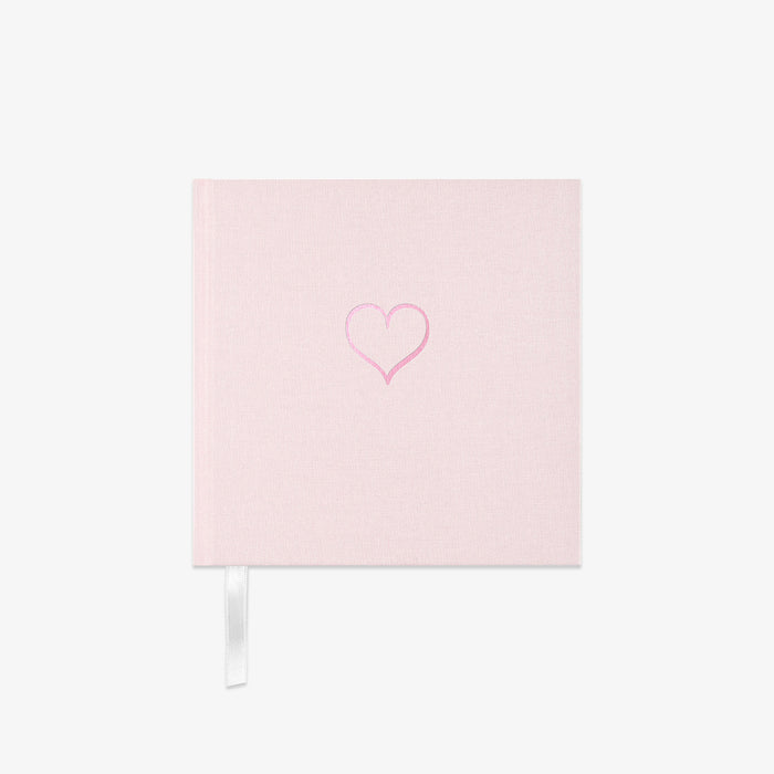 Light pink fabric Notebook with a heart design on a white background