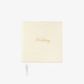 Cream-colored notebook with 'Wedding' in gold text o