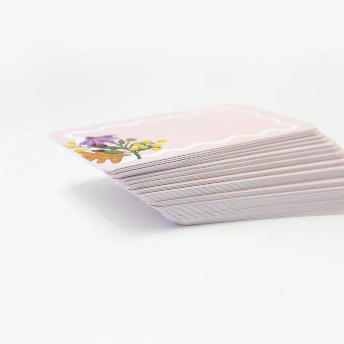 Stack of cards with floral design on a white background
