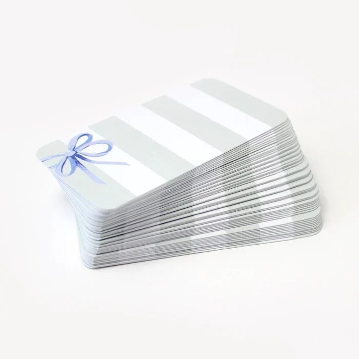 Stack of pocket cards with a blue bow on a white background