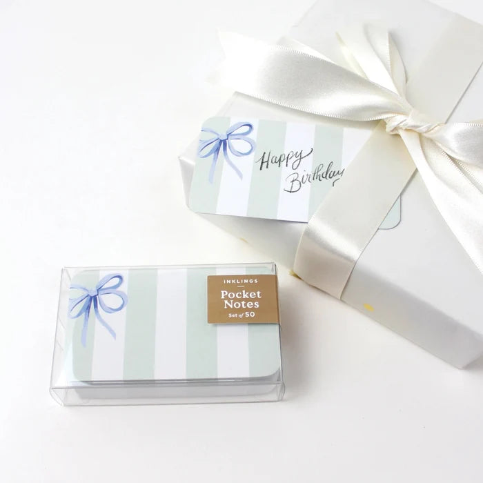 Pack of pocket notes with a decorative bow and 'Happy Birthday' message on a white background