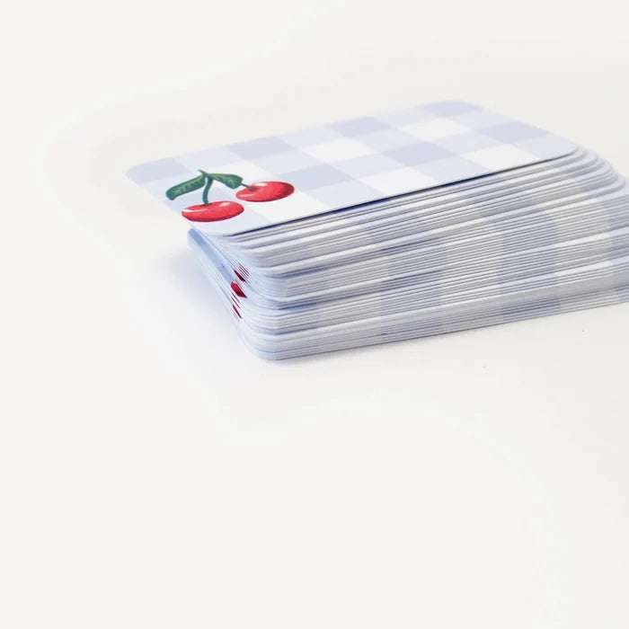 Stack of playing cards with a cherry design on a white background