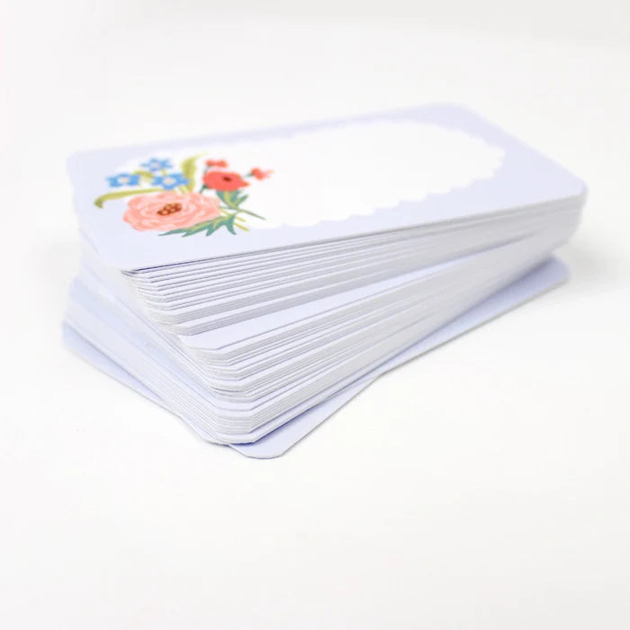 Stack of white cards with floral designs on a white background