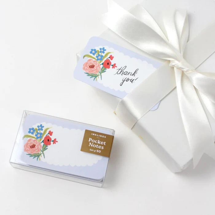 Box of pocket notes with floral design and 'thank you' card on a white background