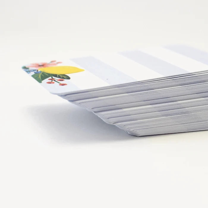 Stack of white cards with a colorful floral lemon design on one card, on a white background