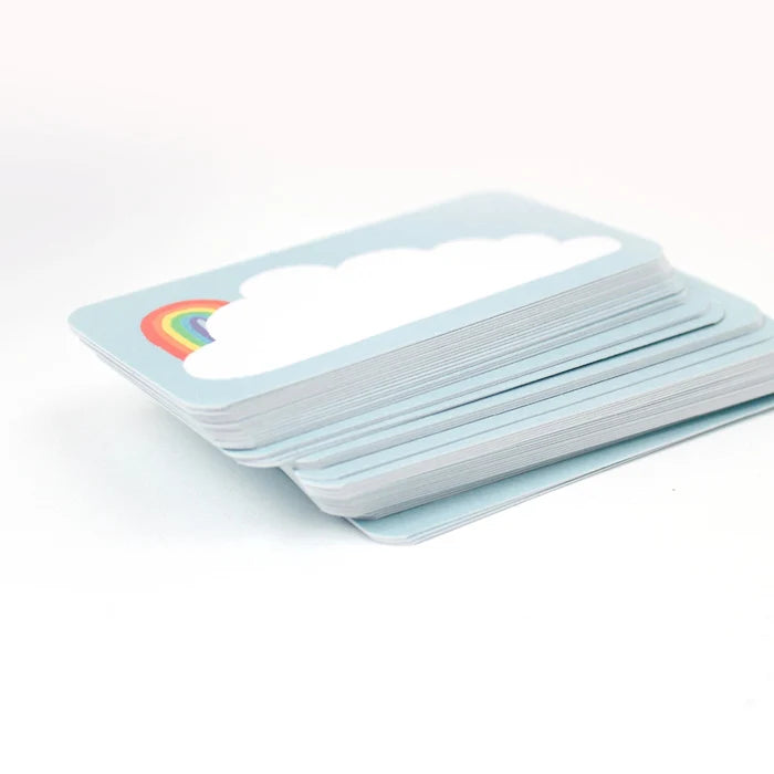 Pack of cards with a rainbow and cloud design on a light blue card.