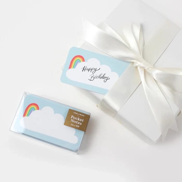 Gift set with rainbow-themed pocket notes and a card on a white background