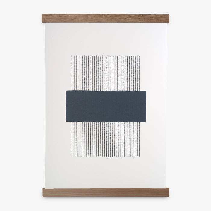 A navy and white geometric line print framed in an oak frame, with a magnetic closure.