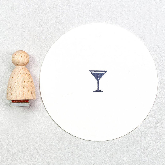 Wooden stamp with a martini glass design on a white background