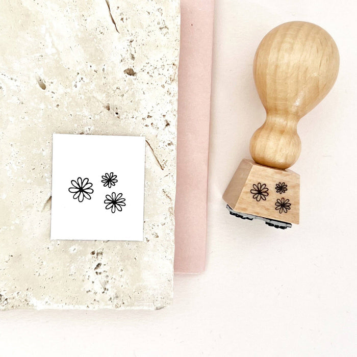 Wooden stamp with floral designs on a white surface