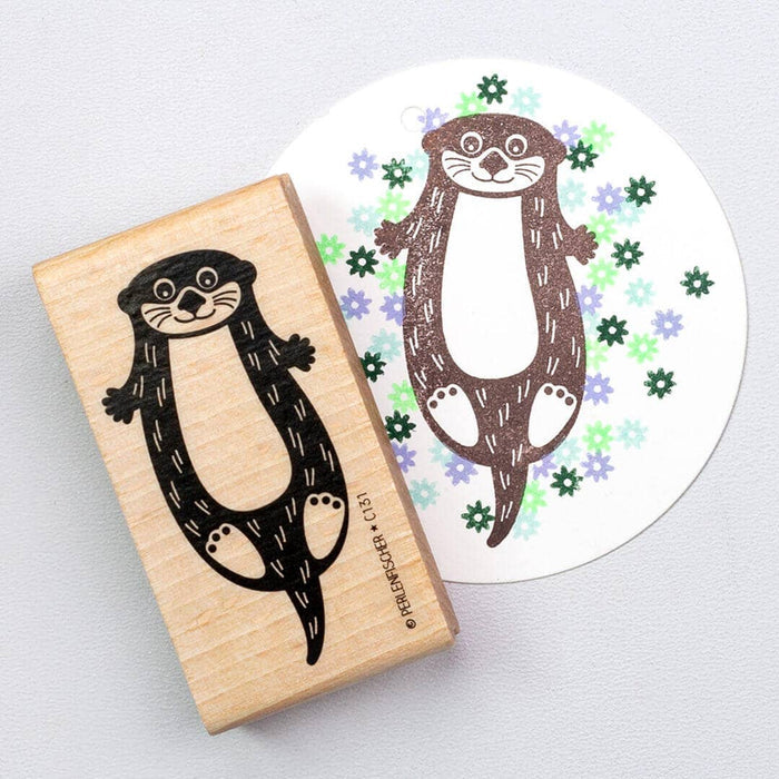Rubber stamp with otter and printed design of an otter on a white background