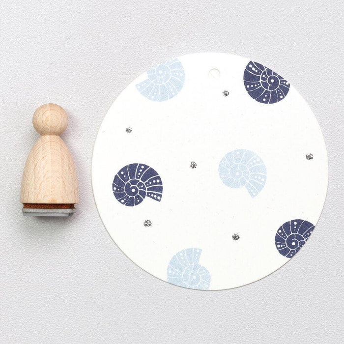 Shell stamp pad with blue and gray Shell stamps on a white background