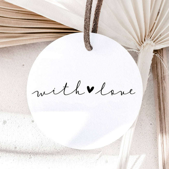 Round white tag with 'with love' text and heart symbol, hanging against a neutral background.