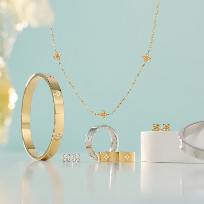 Gold and silver stainless steel jewelry set including bangle bracelet, rings, necklace and stud earrings with pavé flower details, hypoallergenic jewelry for sensitive skin, tarnish free, waterproof and affordable luxury in Canada.