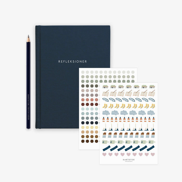 Navy blue notebook with 'REFLEKSIONER' text, a pencil, and a sheet of stickers on a white background.