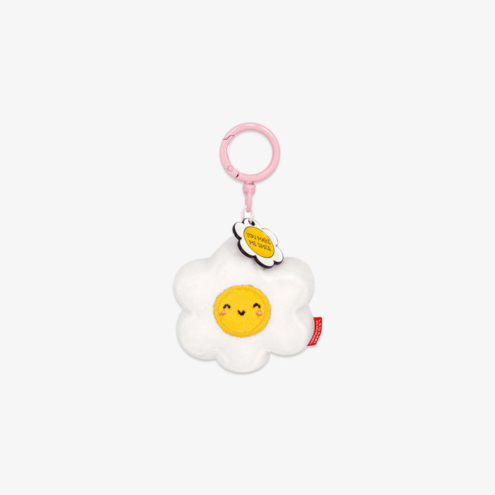 Plush toy shaped like a white and yellow flower with a smiling face on a white background