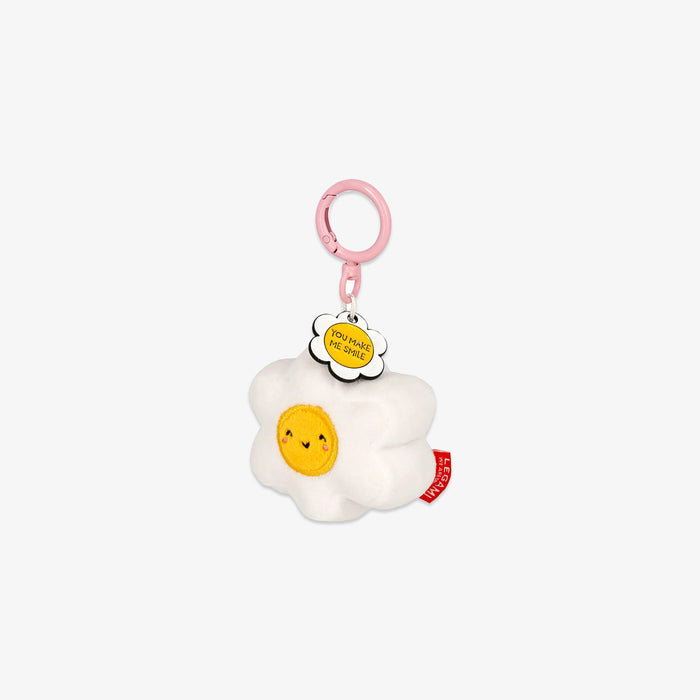 Plush keychain shaped like a white and yellow flower with a smiling face on a white background