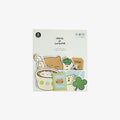 Packaged product with cute sticker illustrations of cats and a shamrock on a white background