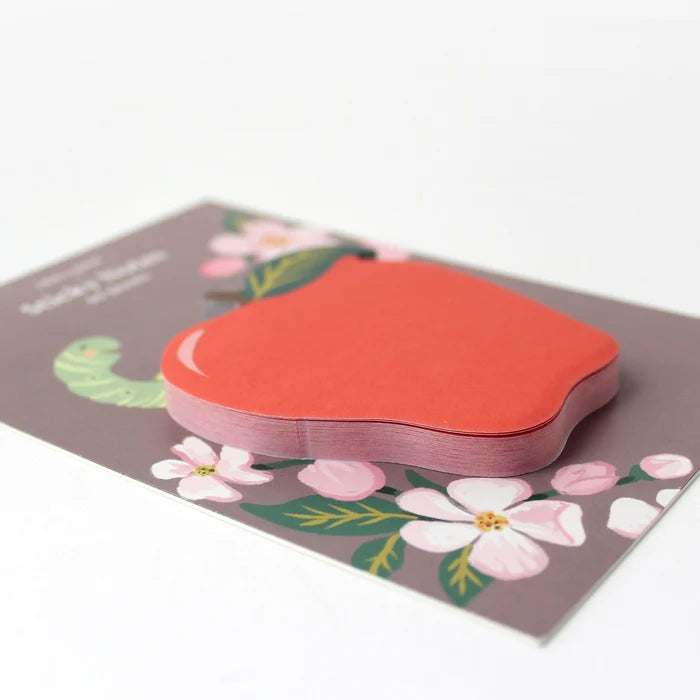 Red apple-shaped sticky notes on a floral background