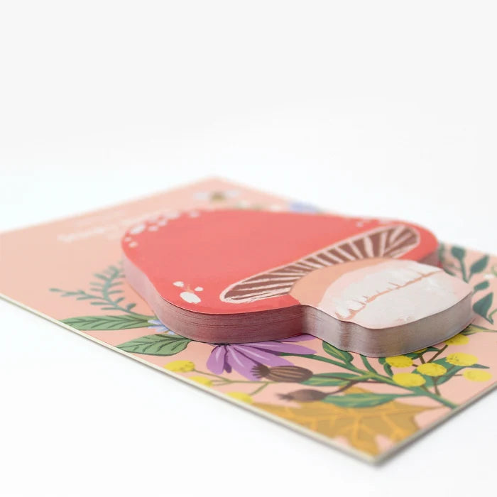 Mushroom-shaped sticky notes on a floral design on a white background