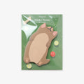 Sticky notes with a puppy-shaped design on a green background