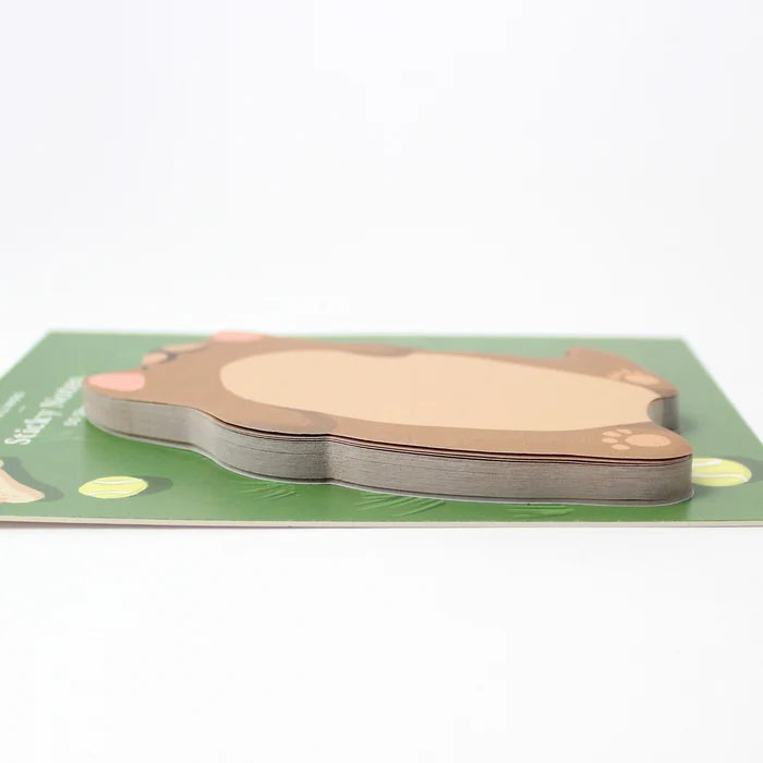 Dog-shaped sticky notes on a green base with a white background