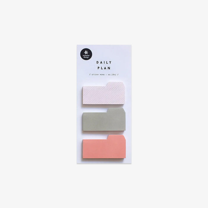 Set of three small sticky notes in white, gray, and coral on a white background with 'Daily Plan' packaging.