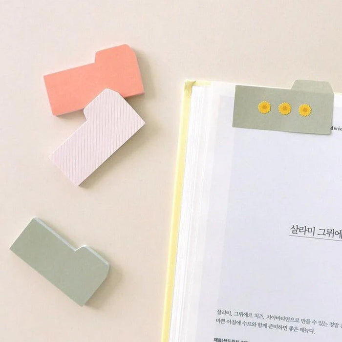 Colorful sticky notes on a notebook with a light background