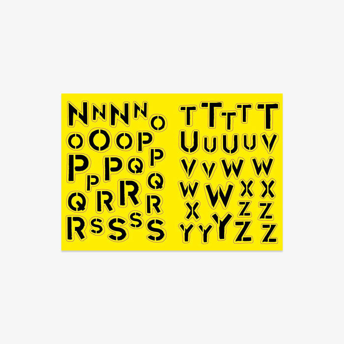 Sheet of black letter stencils on a yellow background