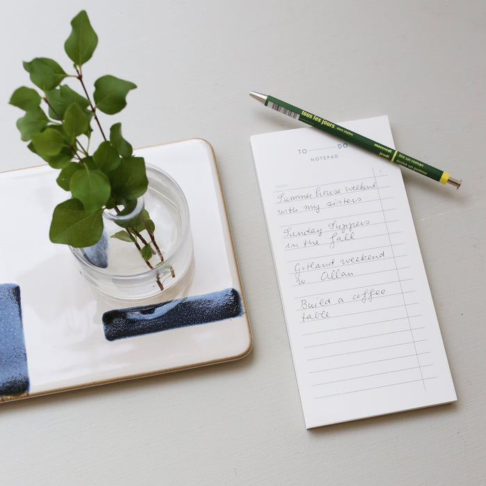Table set up with a white notepad with the text 'TO DO' and example of how to use it.