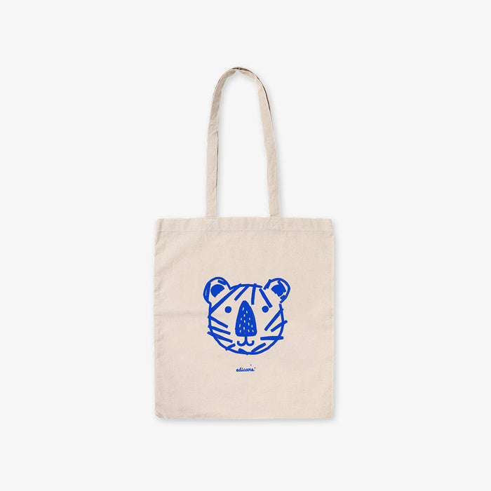 Beige tote bag with blue tiger face design on a white background