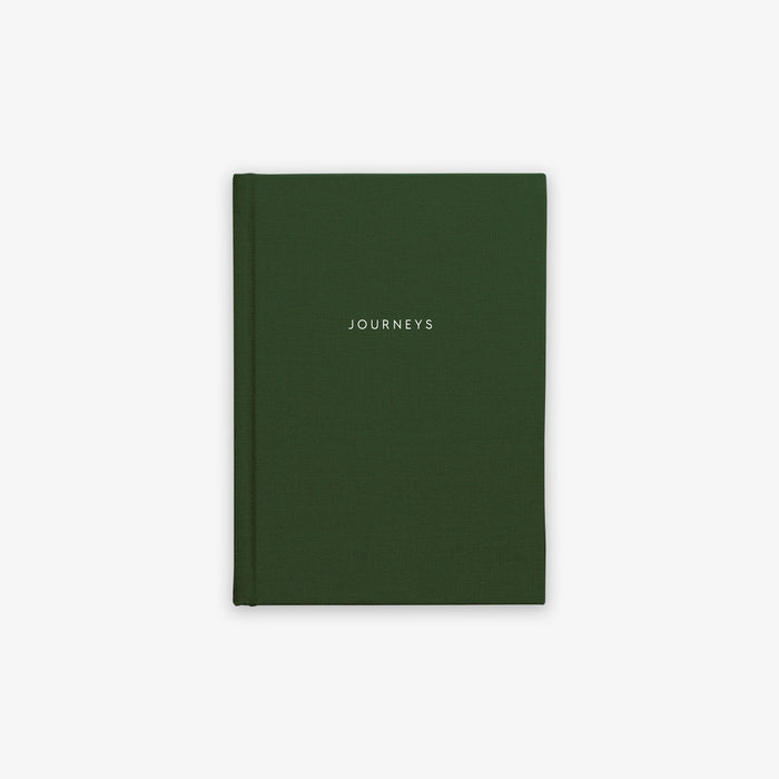 A green, hardcover cloth-bound notebook with the word 'JOURNEYS' printed on the cover in capital letters.