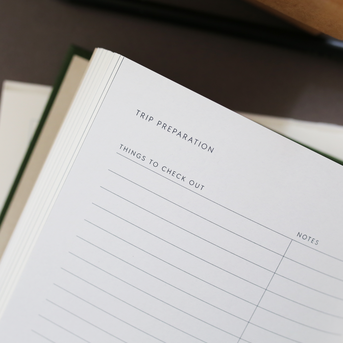 A page in the travel journal with the text 'TRIP PREPRARATION', 'THINGS TO CHECK OUT' and 'NOTES'.