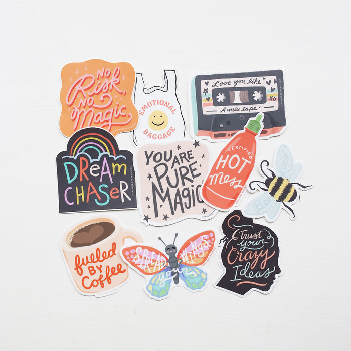 Collection of colorful vinyl stickers with motivational phrases on a white background