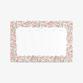 Notepad with floral border on a white background. Weekly schedule.