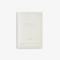 A white weekly planner notebook titled 'Weekly Planner'.