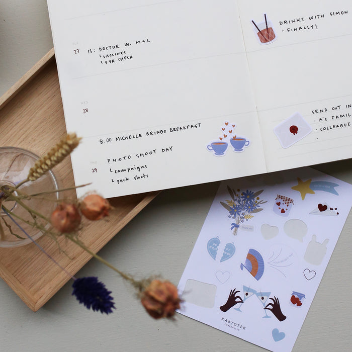 Table set up with the Weekly Planner notebook with examples of how to use it.